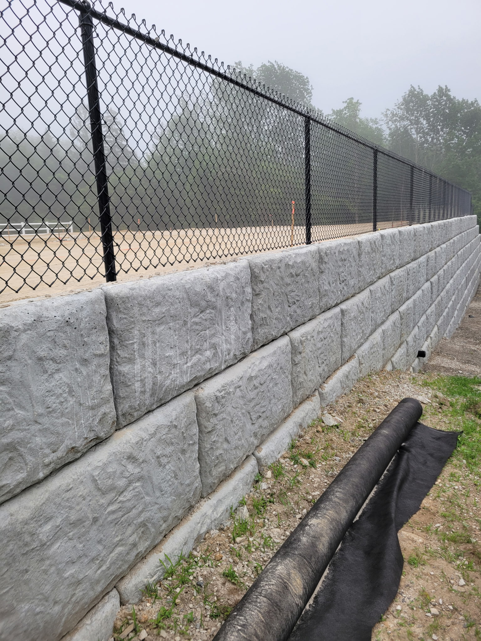 Block retaining wall with chain link fencing Massachusetts